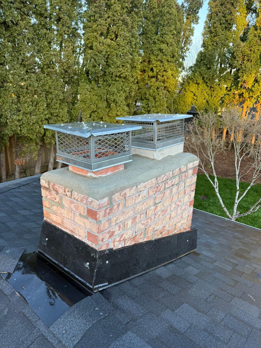 Rebuilt brick chimney with two stainless caps